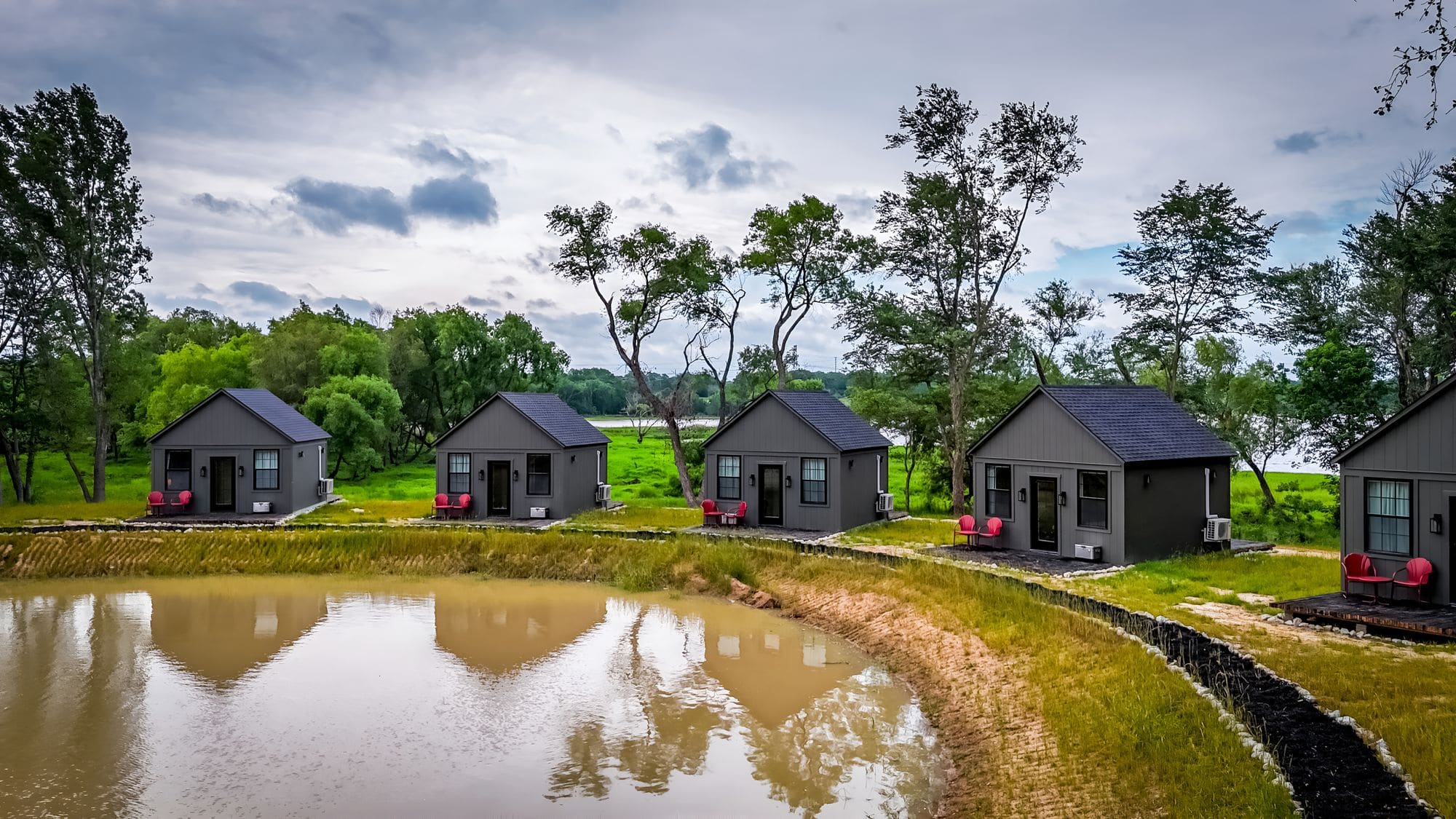 Aerial view of the row of cabins around the pond