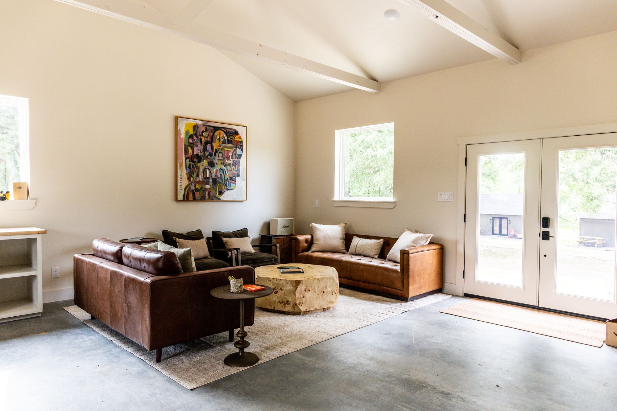 Wide view of the commons barn lounge and kitchen under exposed beams