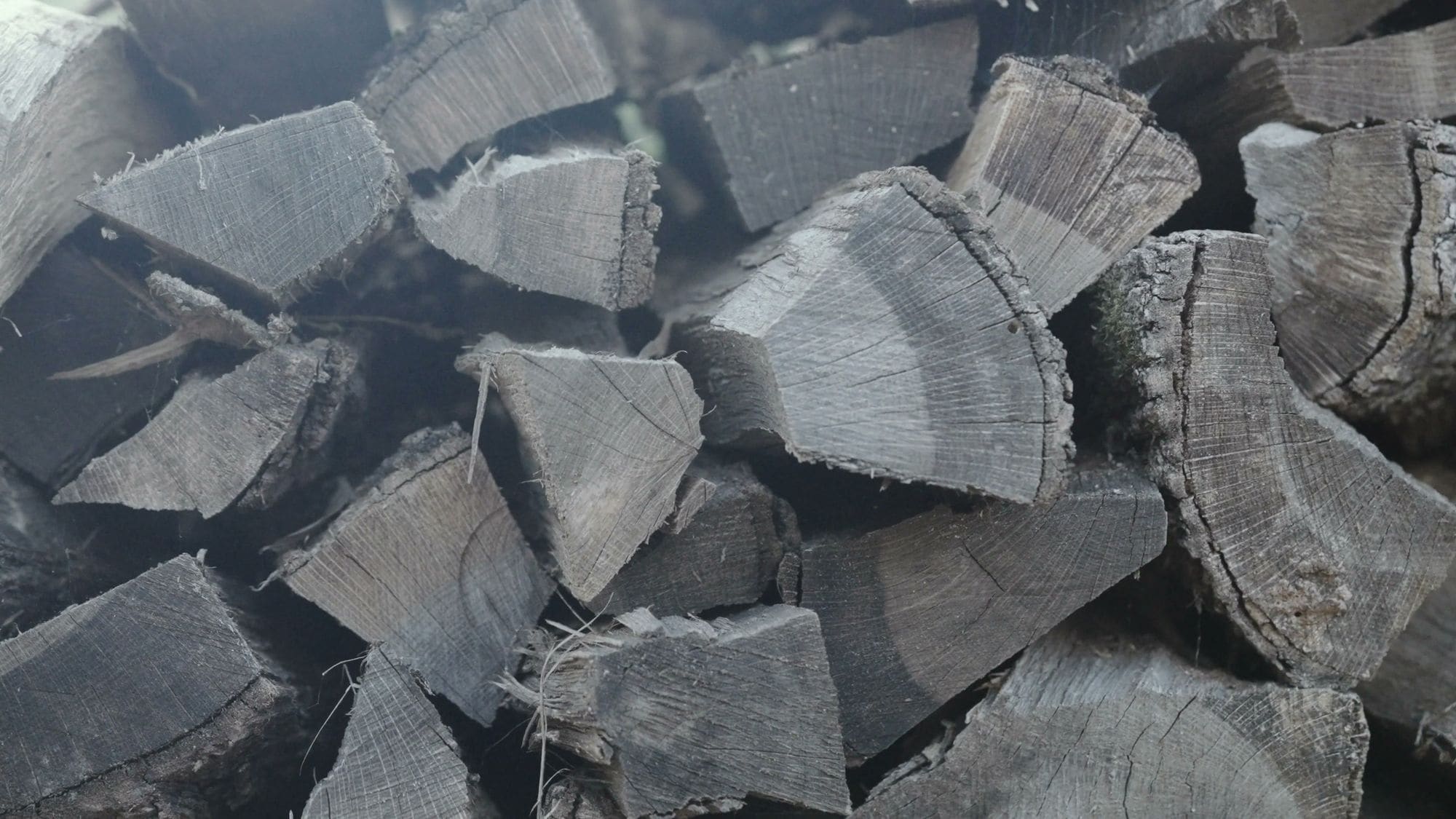 Split firewood stacked for the grill