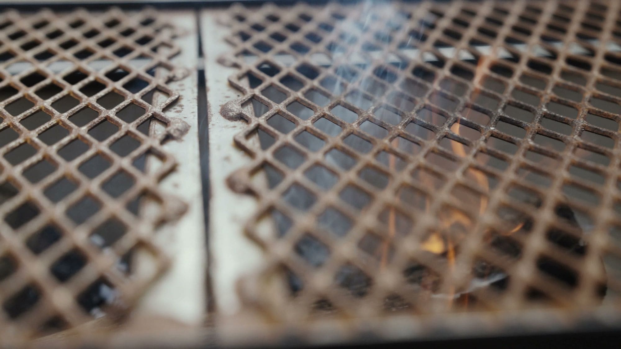 Close-up of the grill grate over glowing coals