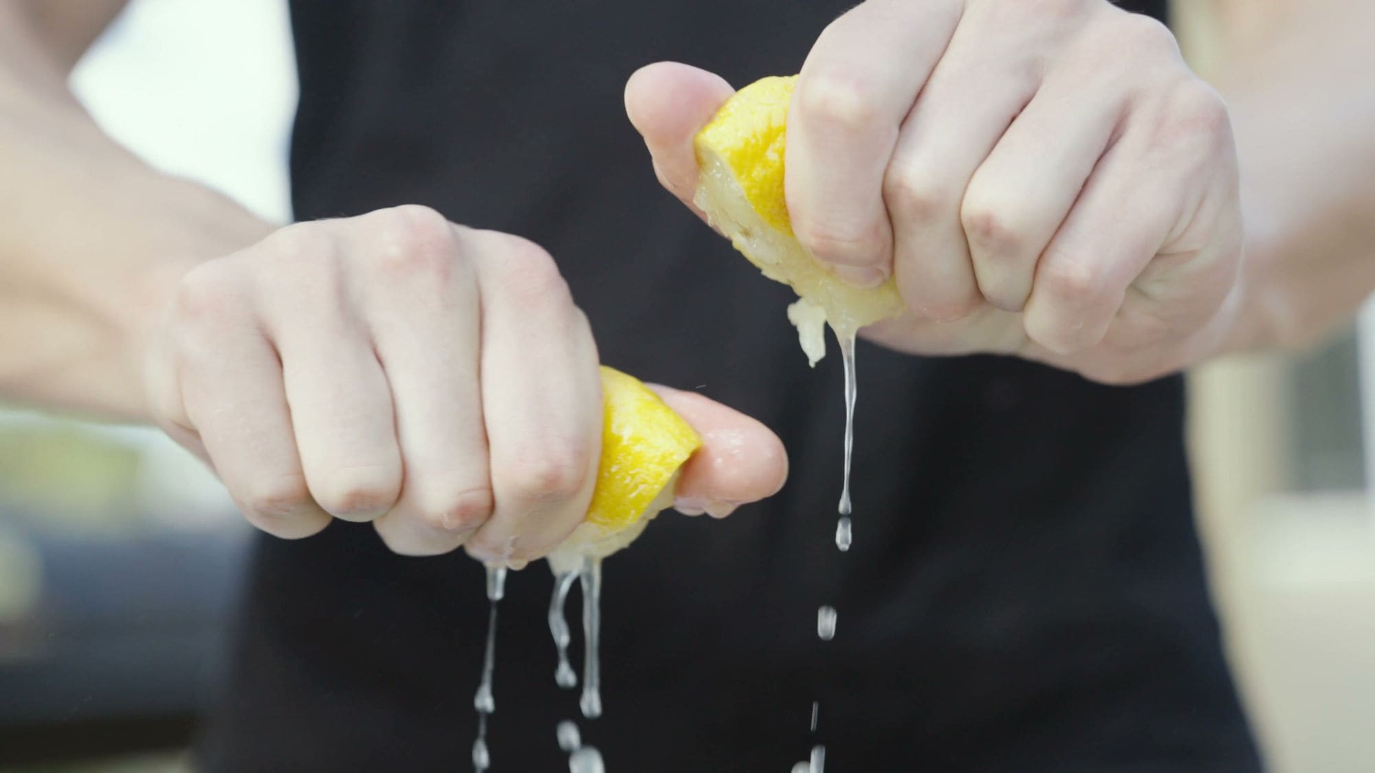 Squeezing lemon over the grill